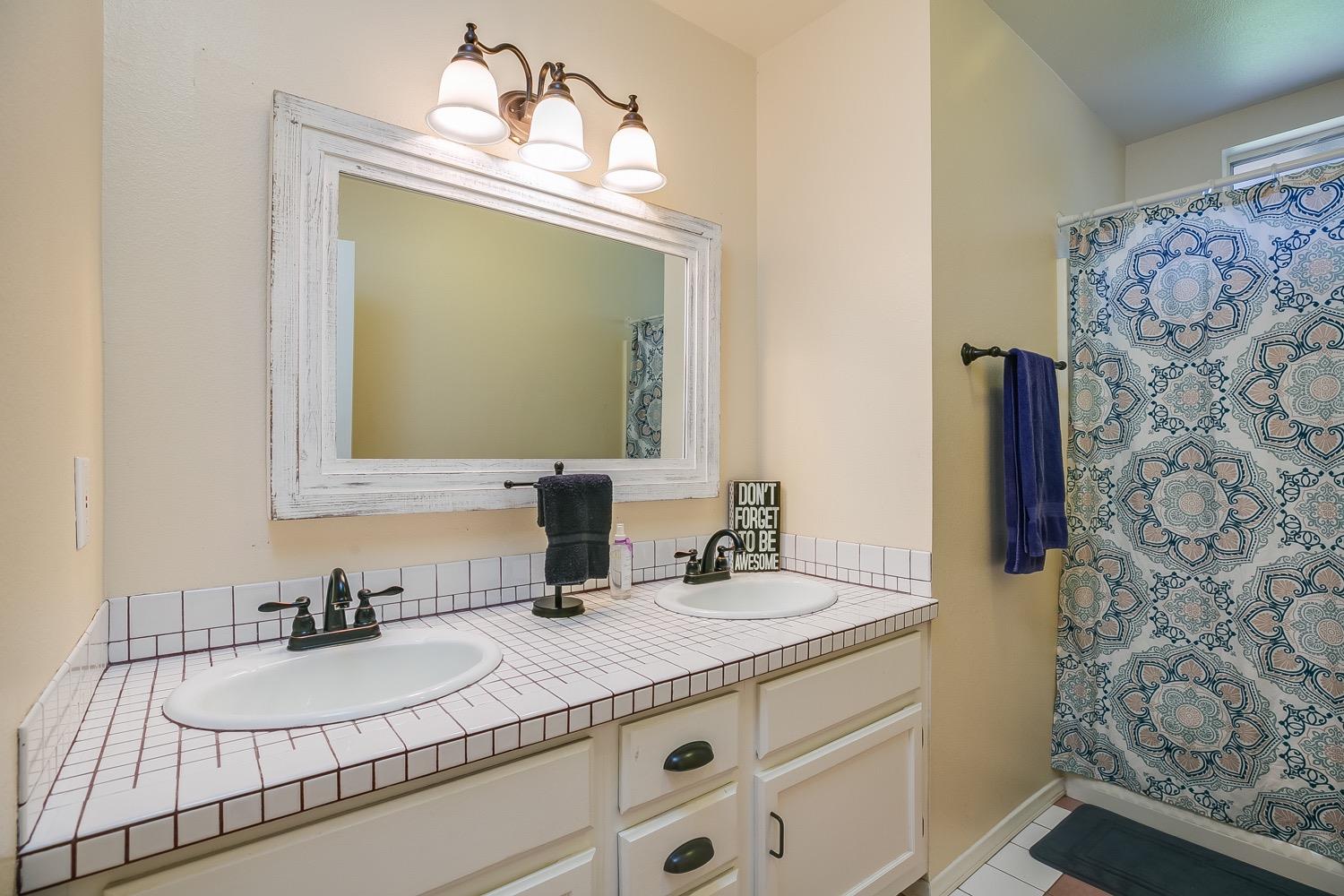 804 Daly Road Ojai, CA 93023 - Photo 16 of 38 a bathroom with a sink and a mirror