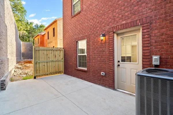 a view of backyard with brick wall and a large window