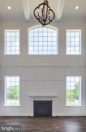 an empty room with windows and balcony