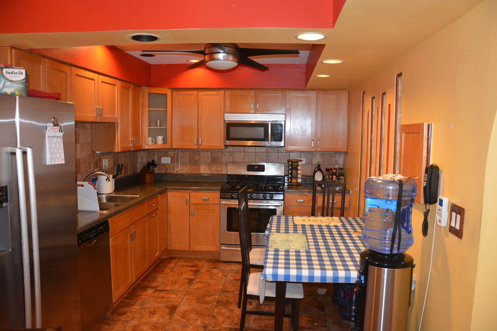 711 Tipperary Court, Unit 2D Schaumburg, IL 60193 - Photo 2 of 17 a kitchen with stainless steel appliances kitchen island granite countertop a refrigerator a stove a sink dishwasher and a microwave
