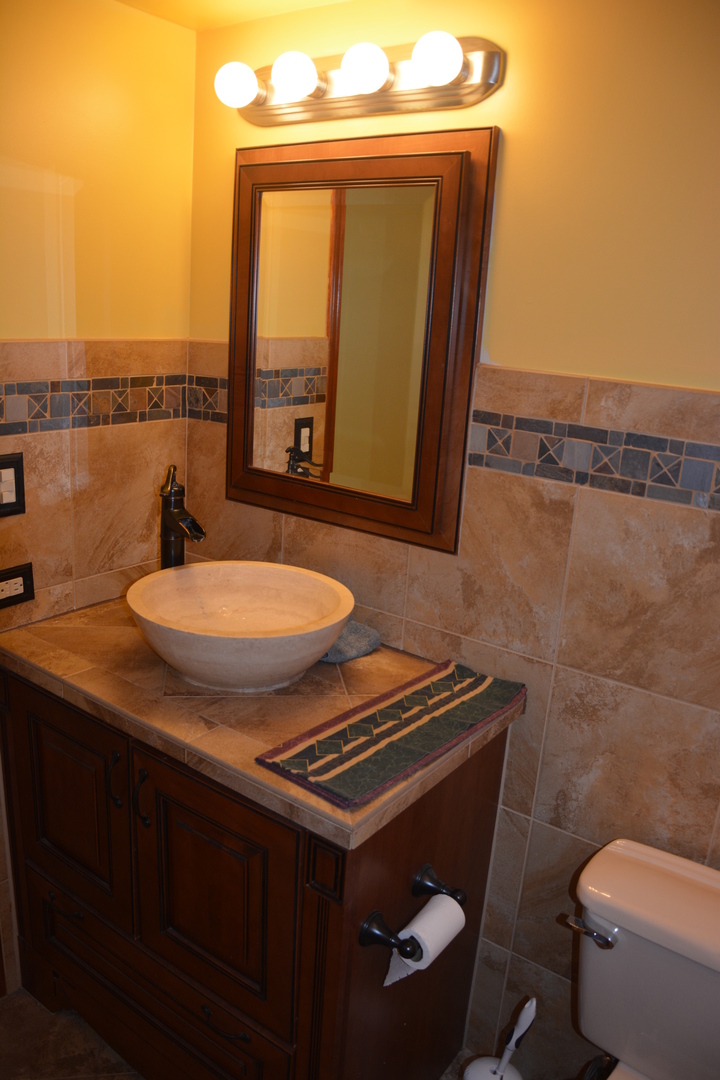 711 Tipperary Court, Unit 2D Schaumburg, IL 60193 - Photo 13 of 17 a bathroom with a sink toilet and mirror