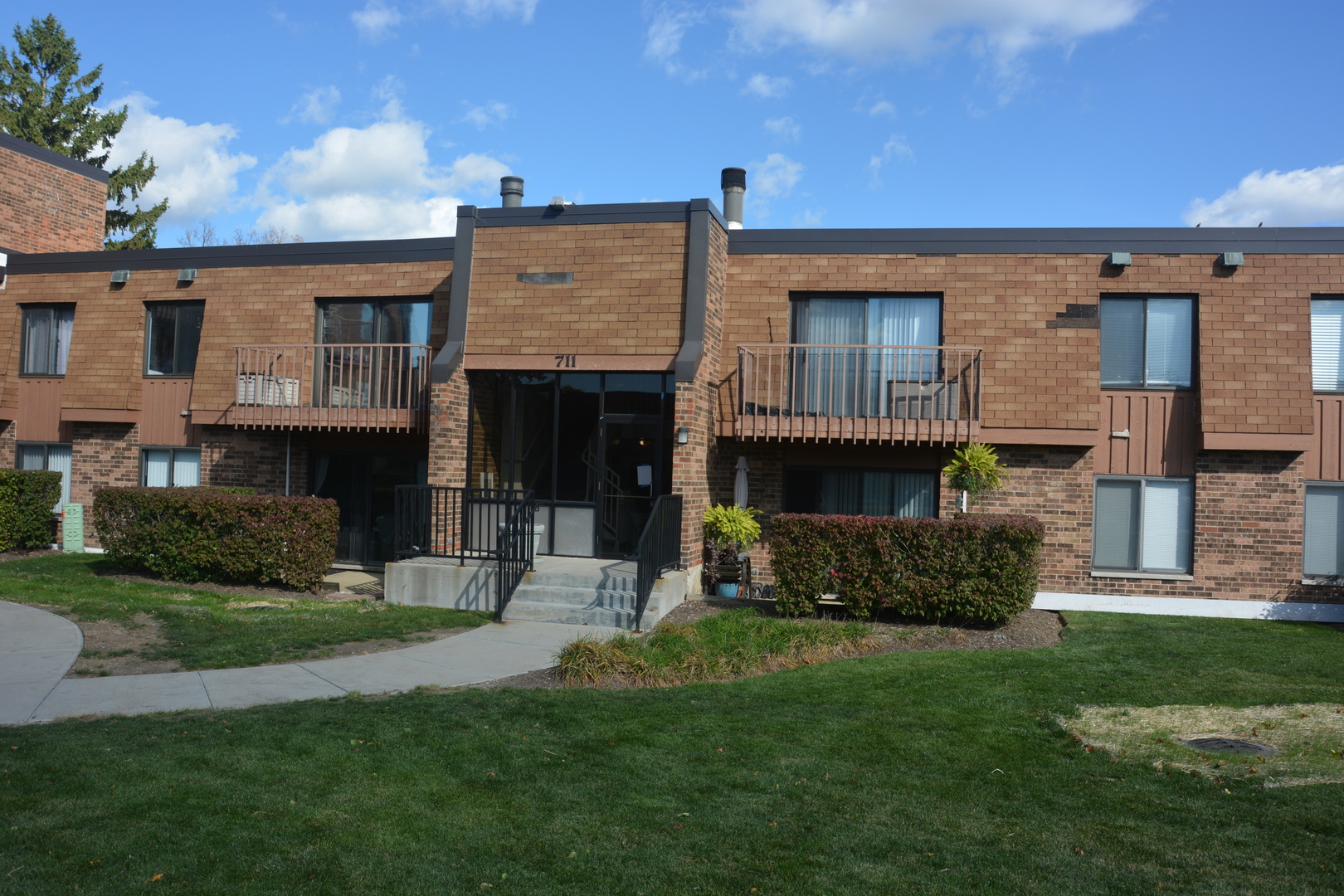 711 Tipperary Court, Unit 2D Schaumburg, IL 60193 - Photo 17 of 17 a view of a house with a yard and a fireplace