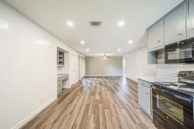 a view of kitchen with sink and wooden floor
