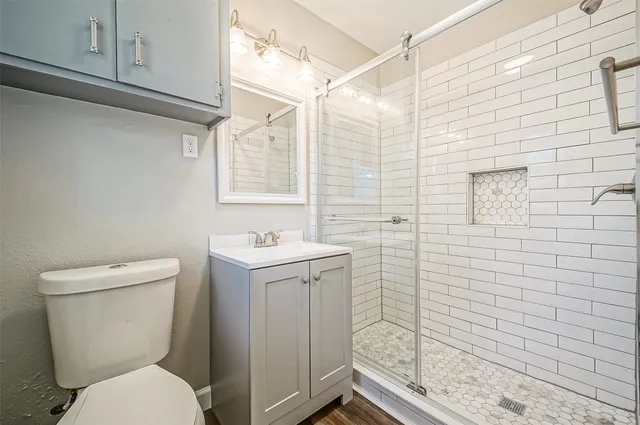 a bathroom with a toilet sink and mirror