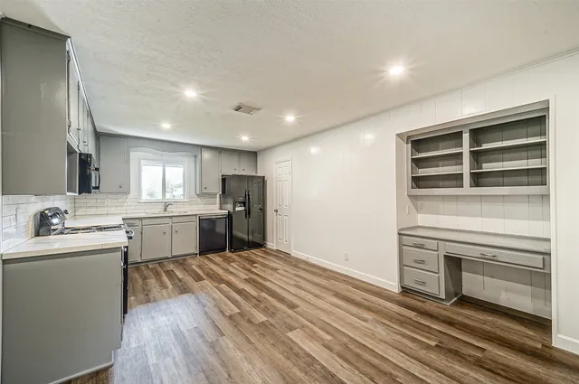 a open kitchen with a sink dishwasher stove and oven