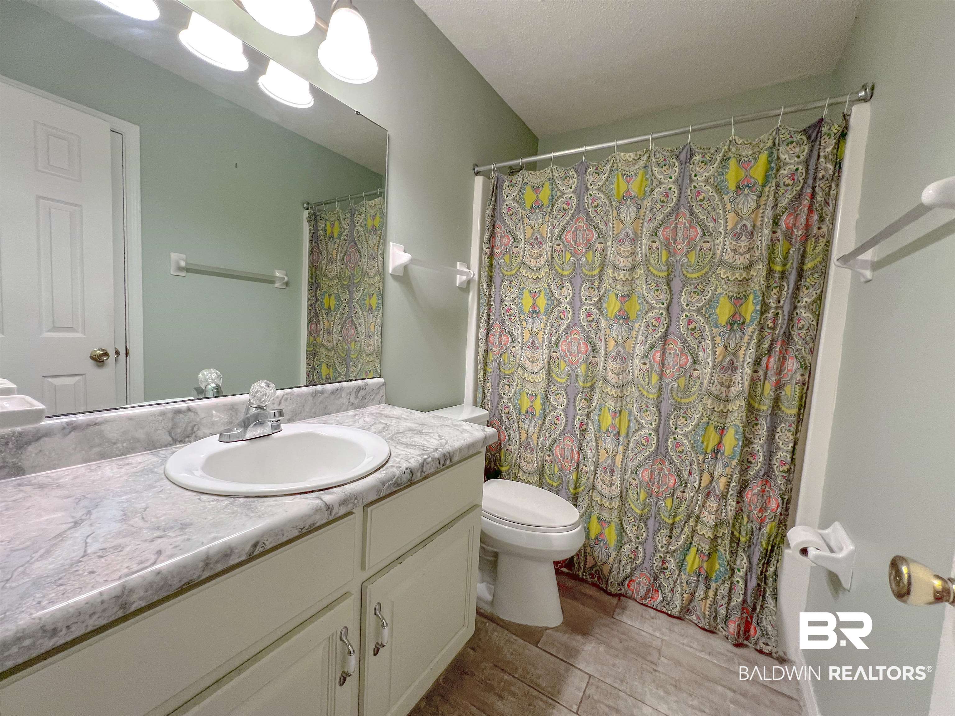 1200 South Juniper Street Foley, AL 36535 - Photo 14 of 23 Bathroom featuring vanity, toilet, tile patterned floors, and a textured ceiling