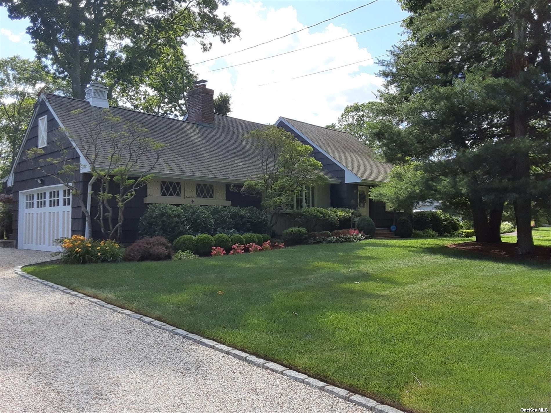 33 Woodhollow Road Great River, NY 11739 - Photo 1 of 1 a front view of a house with a garden