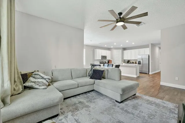 a living room with furniture and kitchen view
