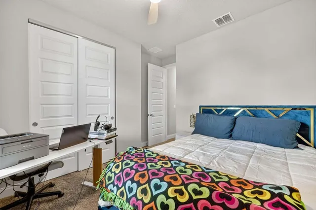 a bedroom with a bed and a desk