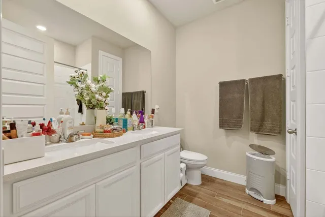 a bathroom with a sink mirror and toilet