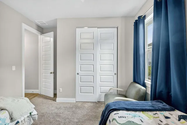a bedroom with a bed and a walk in closet