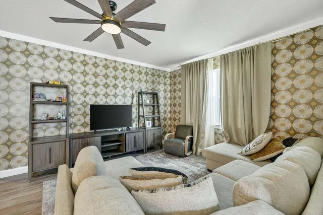 a living room with furniture and a flat screen tv