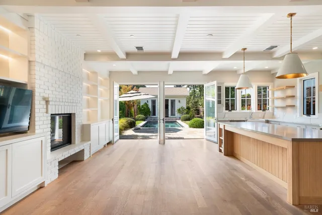 a large room with pool table and chairs