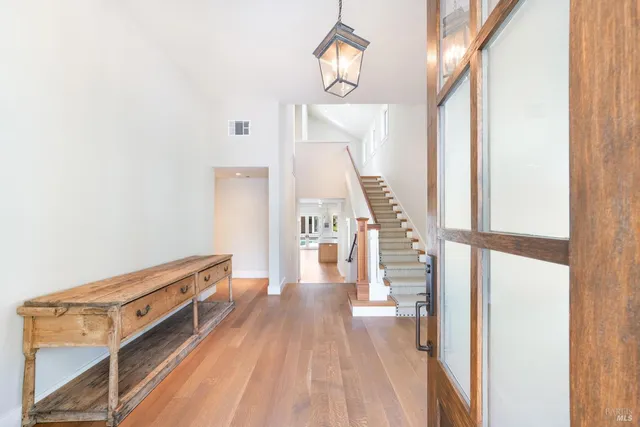 a view of a livingroom with wooden floor and stairs