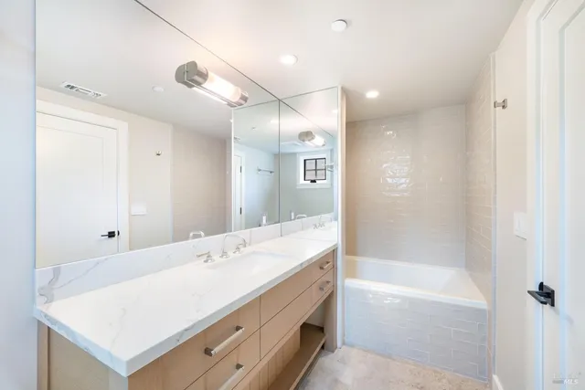 a spacious bathroom with a shower tub double and sink