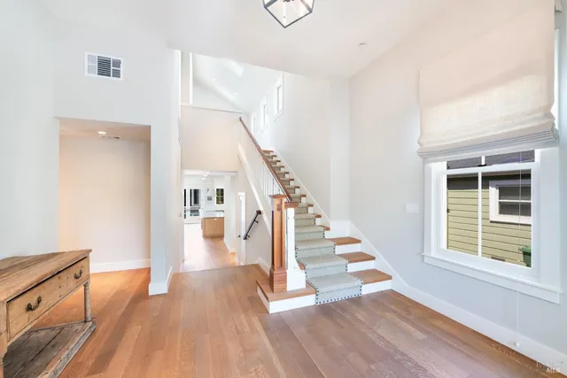 a view of entryway and hall with wooden floor