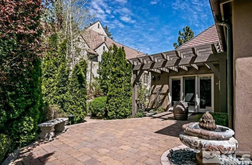 6574 Champetre Court Reno, NV 89511 - Photo 18 of 21 a front view of a house with garden