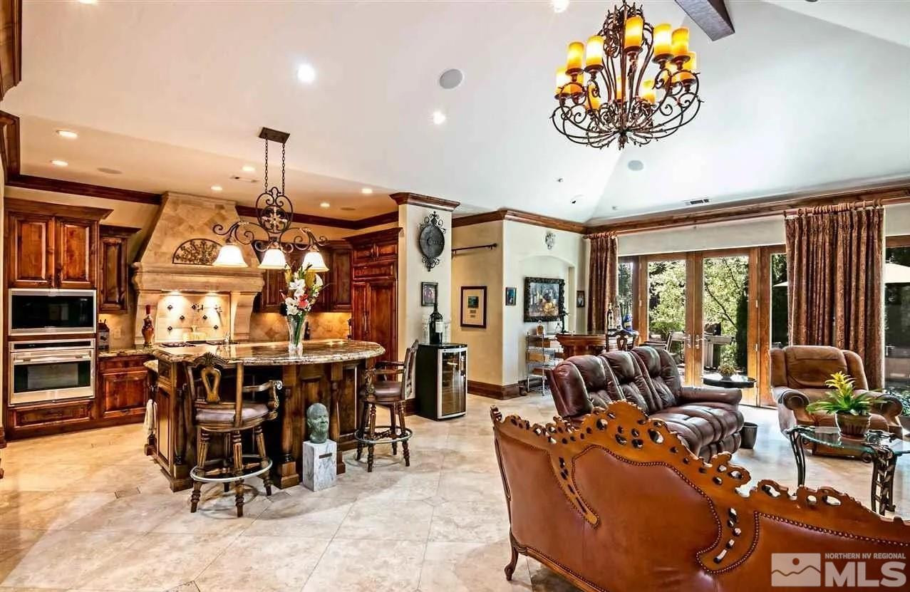 6574 Champetre Court Reno, NV 89511 - Photo 5 of 21 a living room with furniture a chandelier and a large window