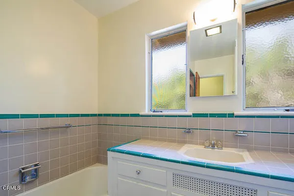 a bathroom with a bathtub and a sink