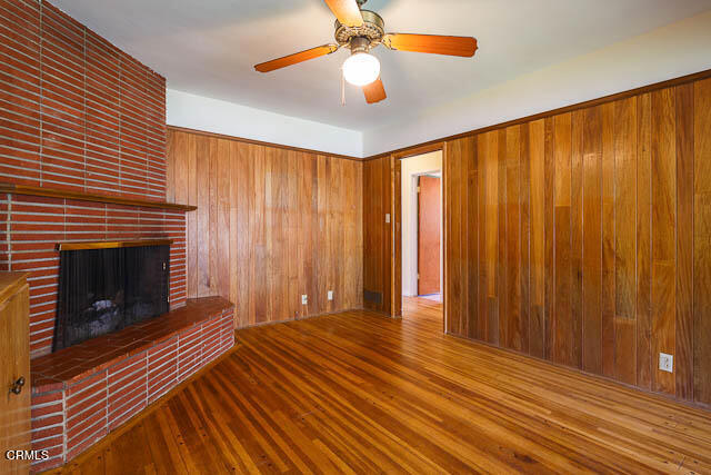 3665 Shadow Grove Road Pasadena, CA 91107 - Photo 17 of 27 a view of an empty room with wooden floor fireplace and a window