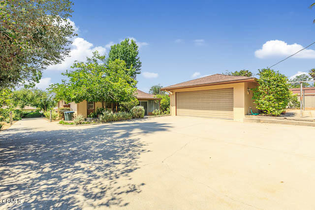 3665 Shadow Grove Road Pasadena, CA 91107 - Photo 24 of 27 a front view of a house with a yard and garage