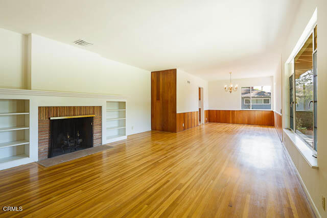 3665 Shadow Grove Road Pasadena, CA 91107 - Photo 7 of 27 a view of empty room with wooden floor and fireplace