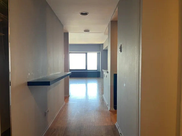 a view of hallway with wooden floor
