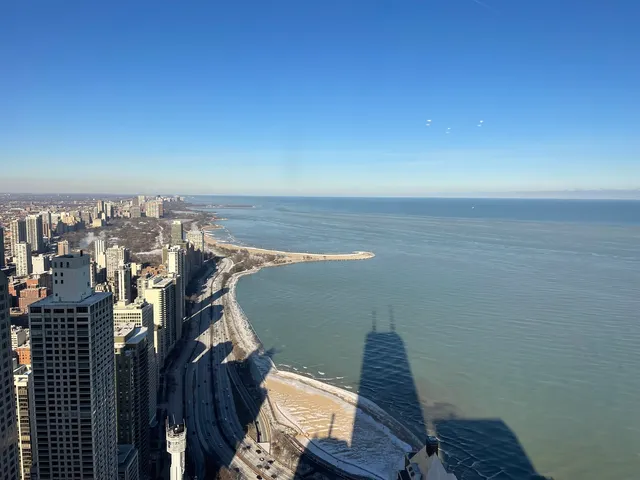 a view of a balcony with chair and wooden floor