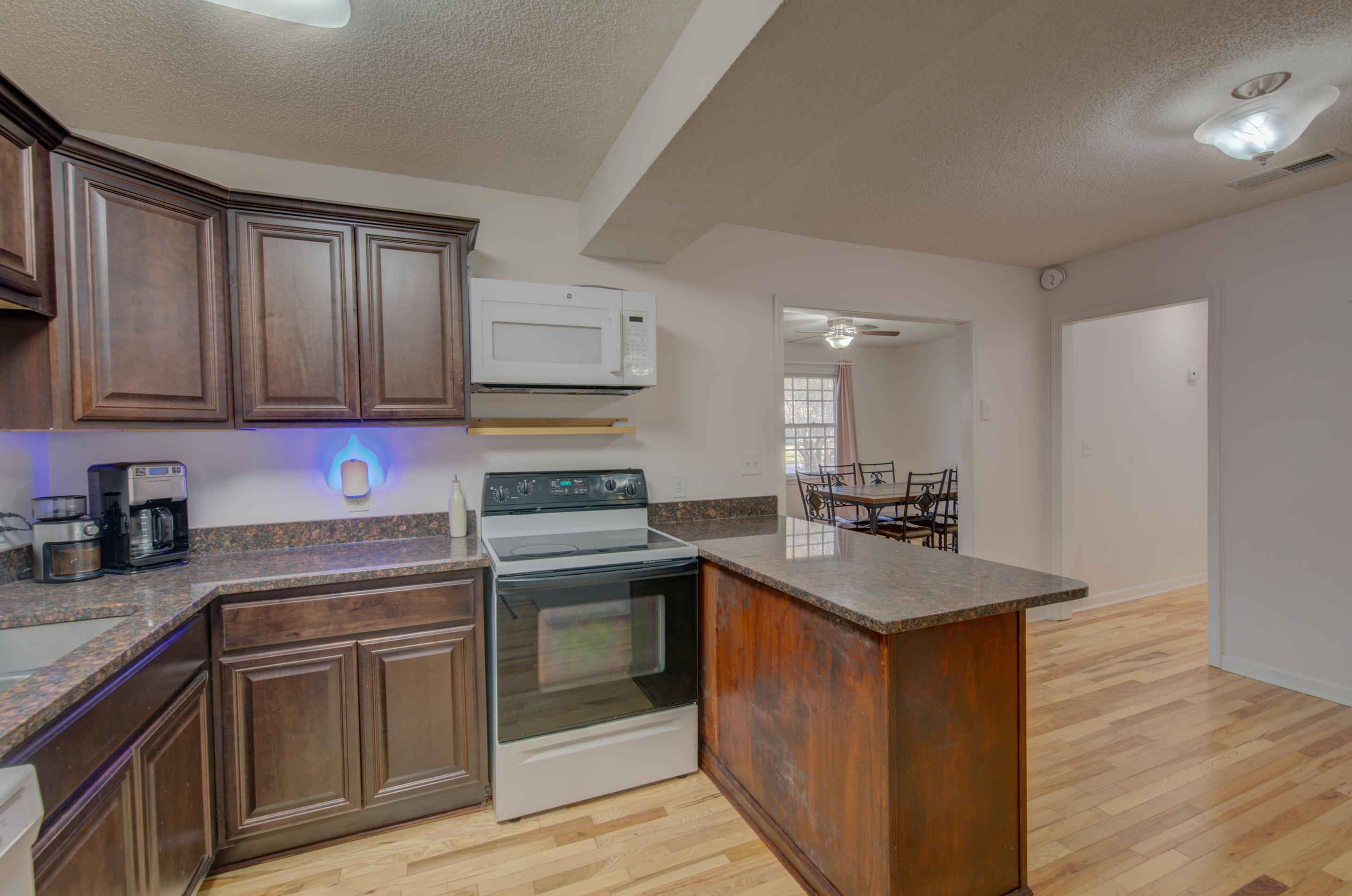 4565 Monaco Road Memphis, TN 38117 - Photo 12 of 23 a kitchen with stainless steel appliances granite countertop a sink stove and refrigerator