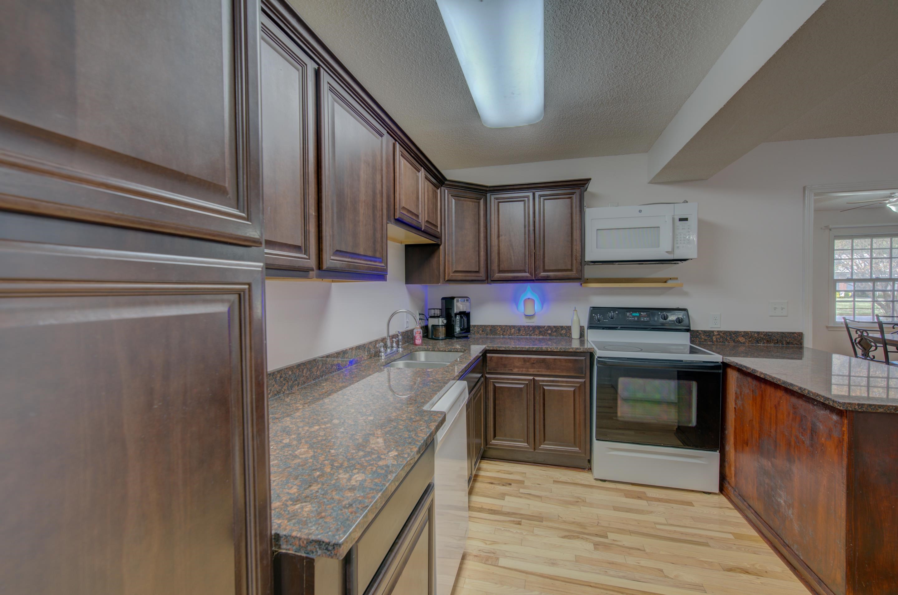 4565 Monaco Road Memphis, TN 38117 - Photo 13 of 23 a kitchen with stainless steel appliances granite countertop a stove a sink dishwasher and a refrigerator