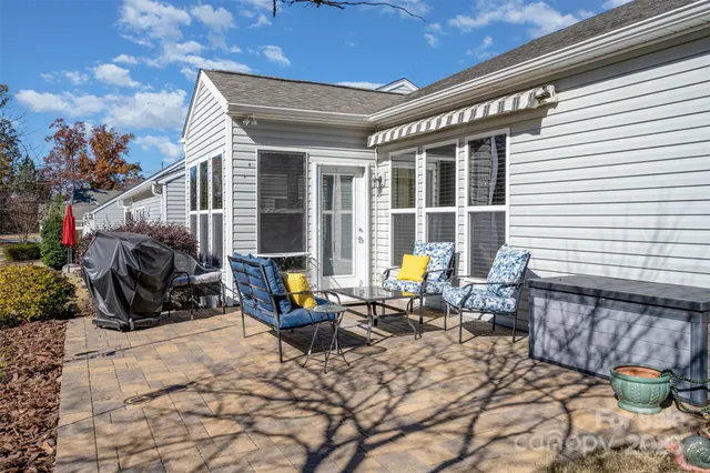 a view of a lounge chairs in the back yard