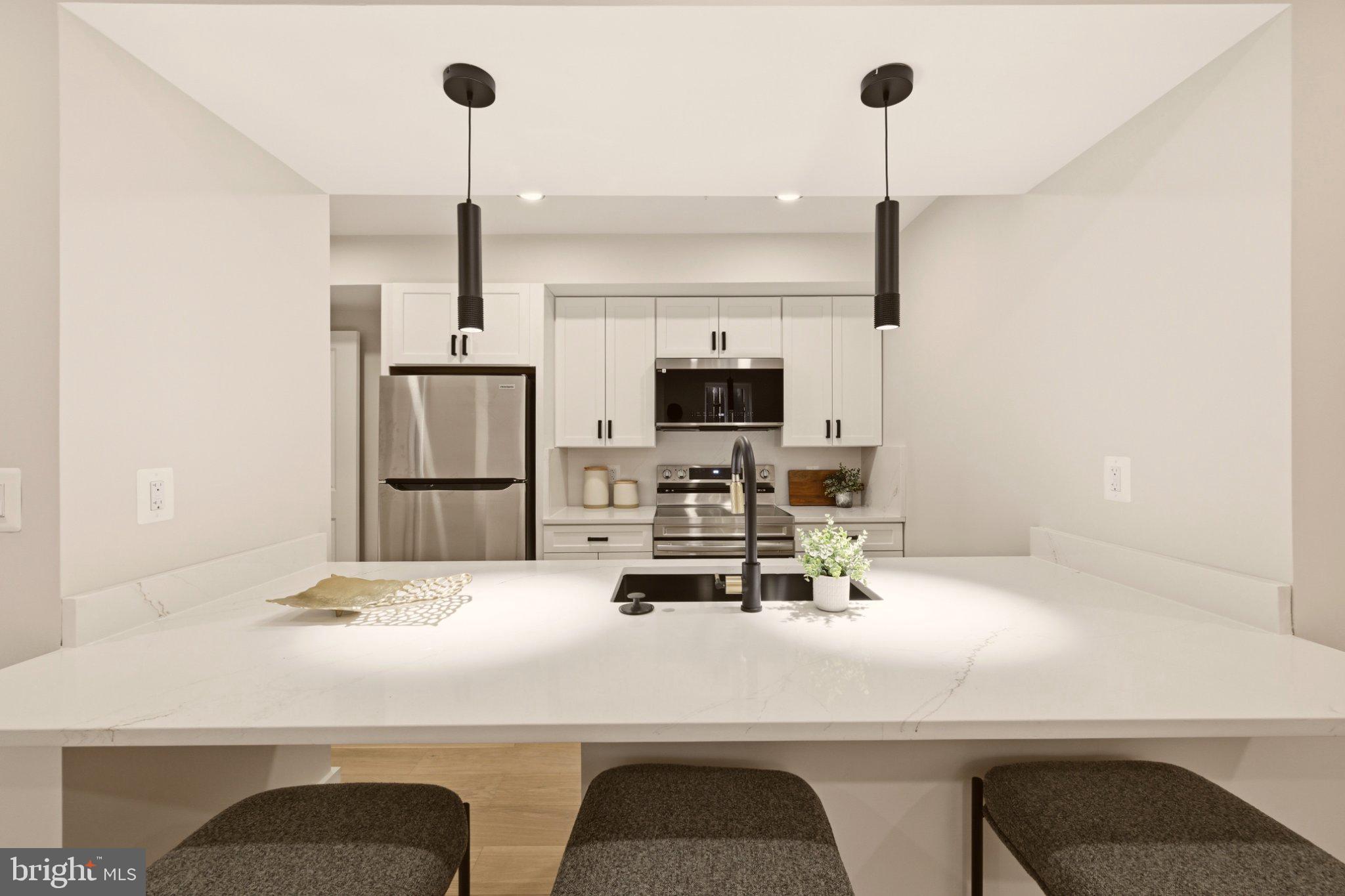 724 Rock Creek Church Road Northwest, Unit B Washington, DC 20010 - Photo 2 of 18 Sleek modern kitchen with elegant finishes.