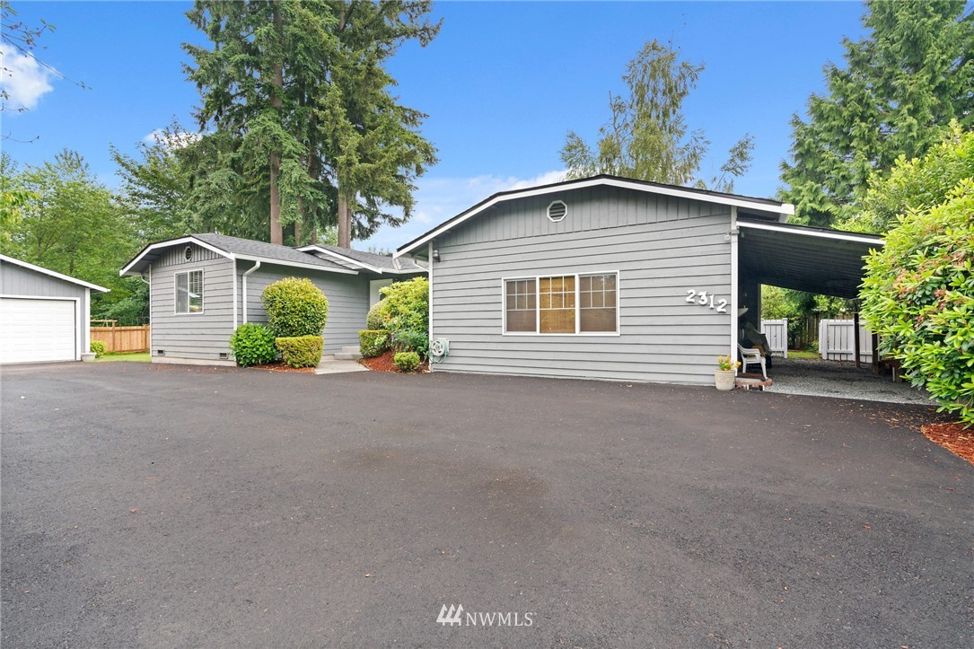 2312 168th Street Southeast Bothell, WA 98012 - Photo 1 of 29 a front view of a house with a garden