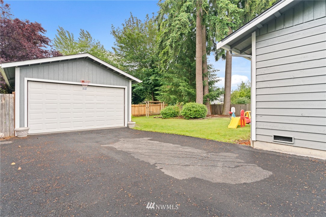 2312 168th Street Southeast Bothell, WA 98012 - Photo 18 of 29 a view of a house with a yard and garage