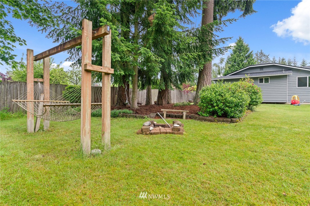 2312 168th Street Southeast Bothell, WA 98012 - Photo 19 of 29 a view of a backyard with a table and chairs under an umbrella