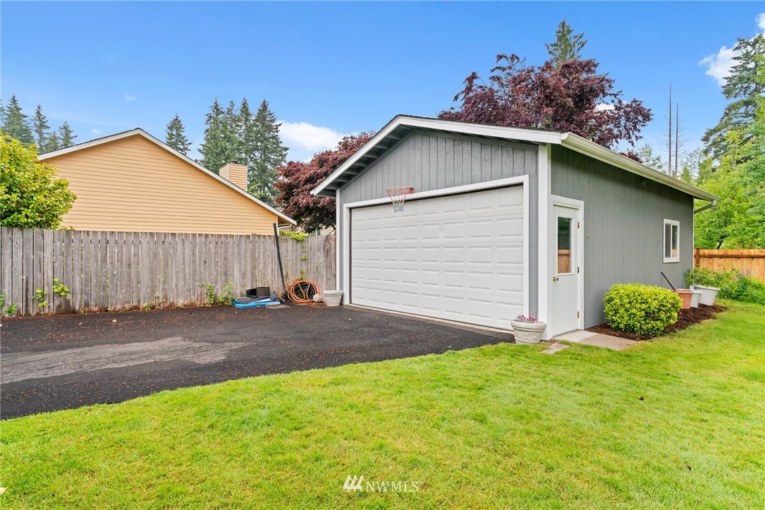 2312 168th Street Southeast Bothell, WA 98012 - Photo 21 of 29 a small white house with a yard and garage