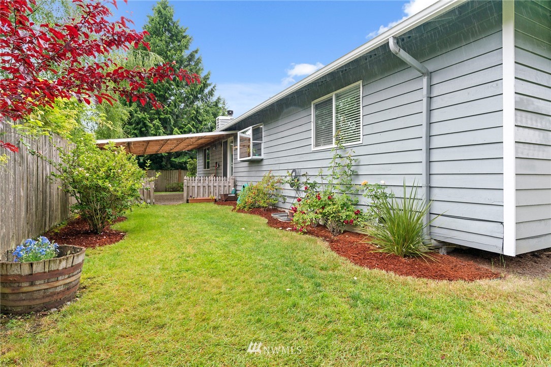 2312 168th Street Southeast Bothell, WA 98012 - Photo 23 of 29 a front view of house with yard and flowers
