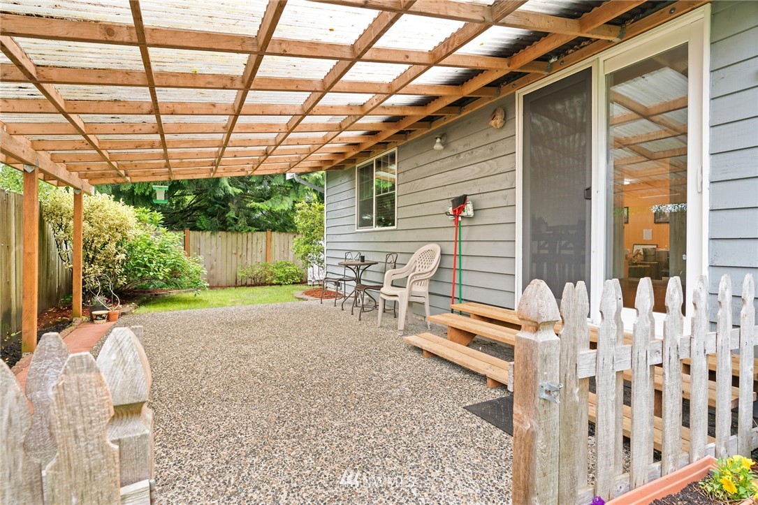 2312 168th Street Southeast Bothell, WA 98012 - Photo 24 of 29 a backyard of a house with barbeque oven table and chairs