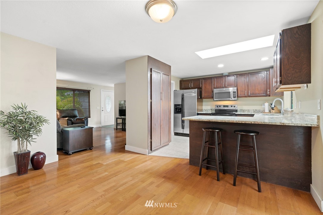 2312 168th Street Southeast Bothell, WA 98012 - Photo 7 of 29 a kitchen with a refrigerator and a sink