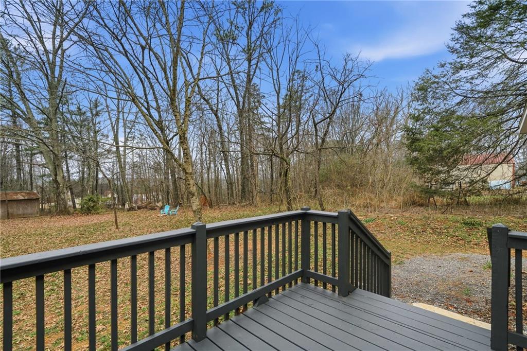 239 Fairview Road Ball Ground, GA 30107 - Photo 16 of 41 a view of balcony with wooden floor and trees