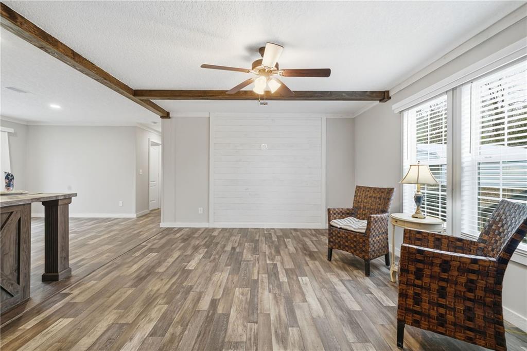 239 Fairview Road Ball Ground, GA 30107 - Photo 19 of 41 a view of a livingroom with furniture and wooden floor