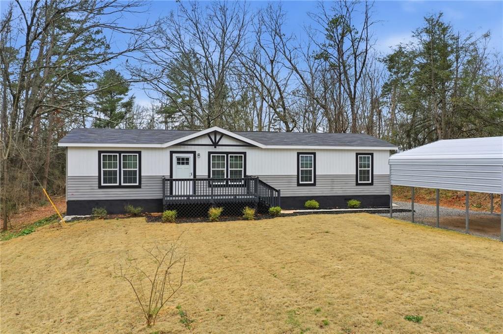 239 Fairview Road Ball Ground, GA 30107 - Photo 3 of 41 a front view of a house with a yard