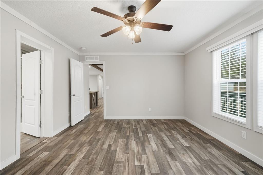 239 Fairview Road Ball Ground, GA 30107 - Photo 31 of 41 a view of empty room with wooden floor and fan