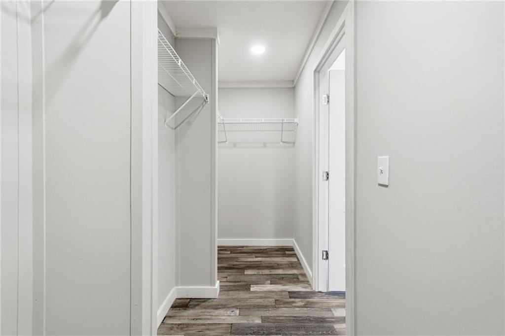 239 Fairview Road Ball Ground, GA 30107 - Photo 32 of 41 a view of a hallway with wooden floor and staircase