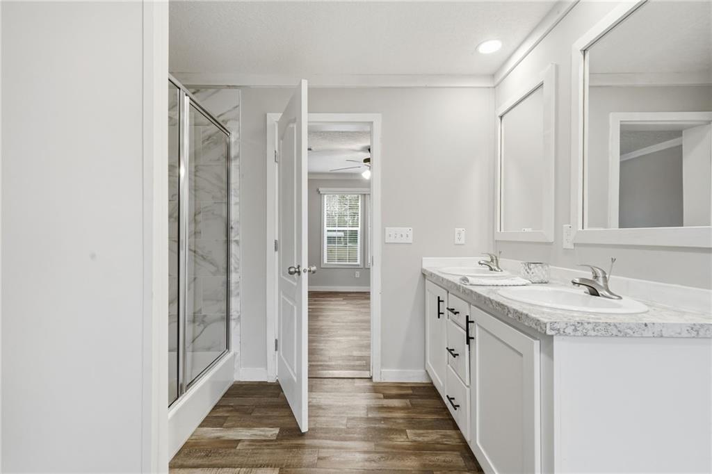 239 Fairview Road Ball Ground, GA 30107 - Photo 34 of 41 a bathroom with a double vanity sink and a mirror