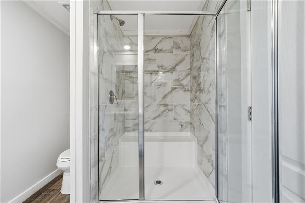 239 Fairview Road Ball Ground, GA 30107 - Photo 35 of 41 a bathroom with a glass shower door