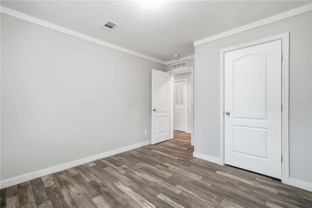 239 Fairview Road Ball Ground, GA 30107 - Photo 40 of 41 a view of empty room with wooden floor
