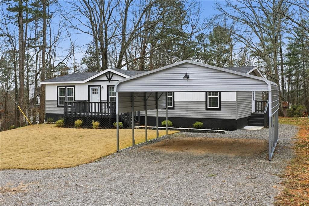 239 Fairview Road Ball Ground, GA 30107 - Photo 4 of 41 a front view of a house with yard patio and garage