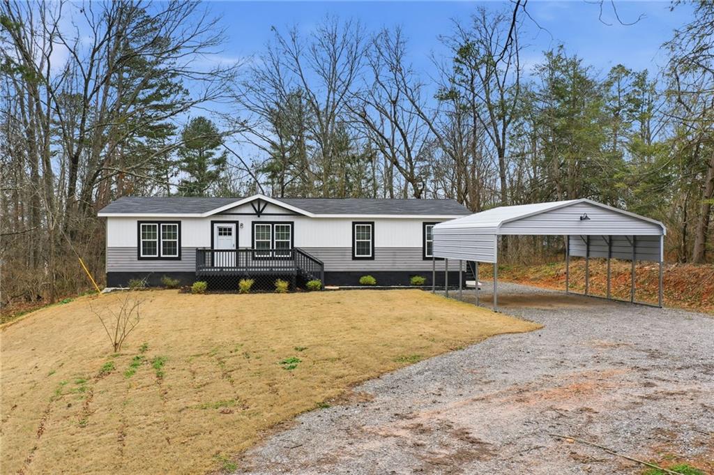 239 Fairview Road Ball Ground, GA 30107 - Photo 6 of 41 a front view of a house with yard and trees