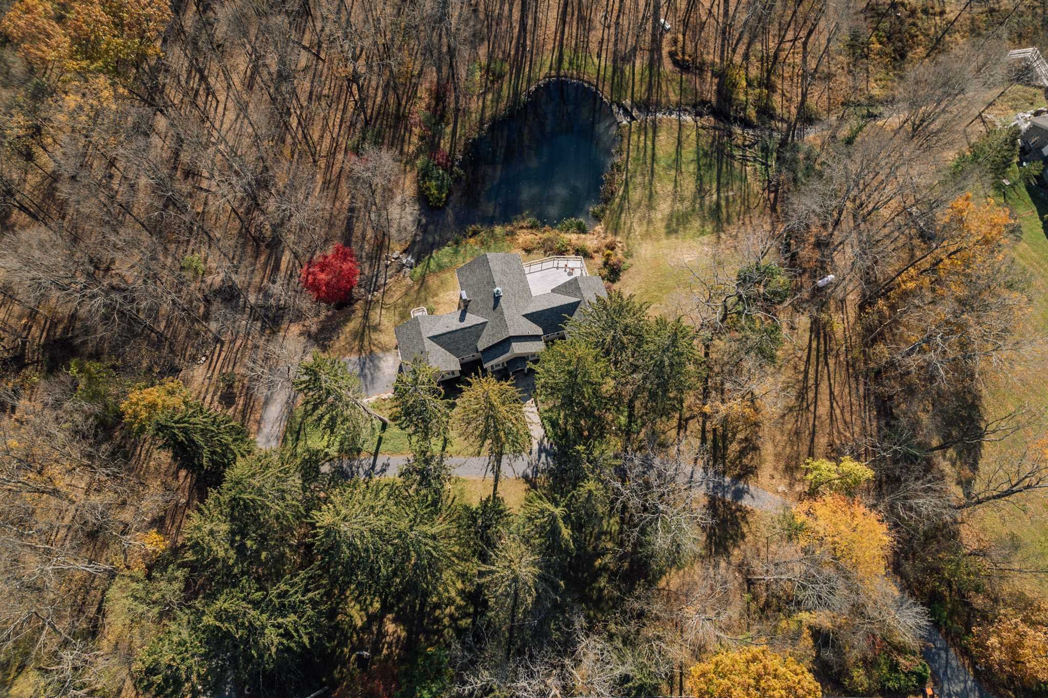 18 Altamont Road Millbrook, NY 12545 - Photo 34 of 35 a backyard of a house with table and chairs under an umbrella
